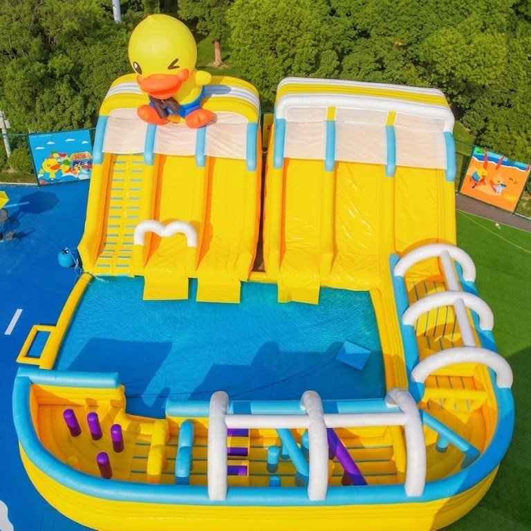 Yellow duck-themed inflatable slide and obstacle area