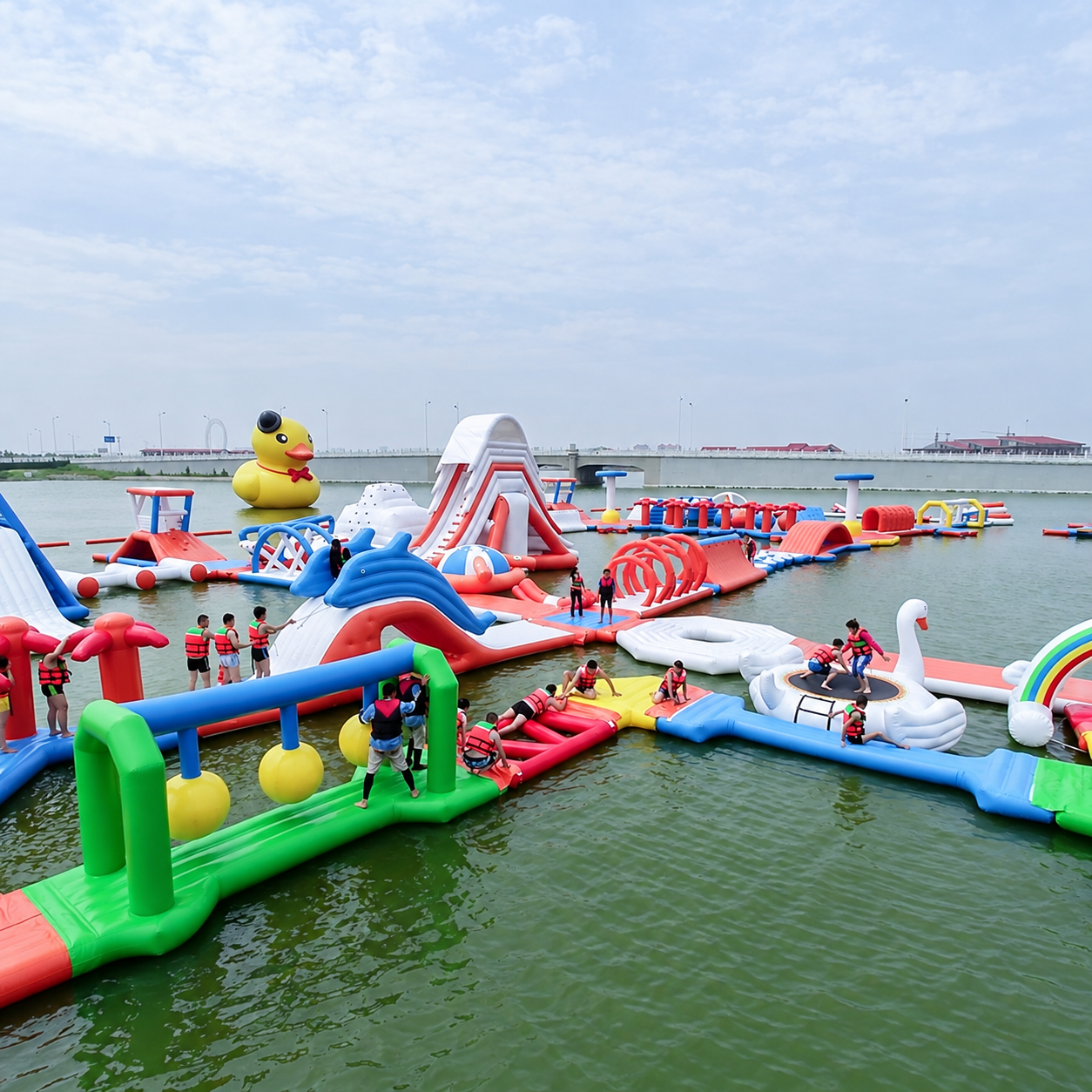 Colorful floating inflatable water park with slides, arches, and climbing obstacles