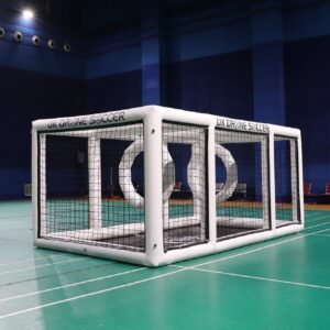 White inflatable drone soccer arena with black netting in a gym
