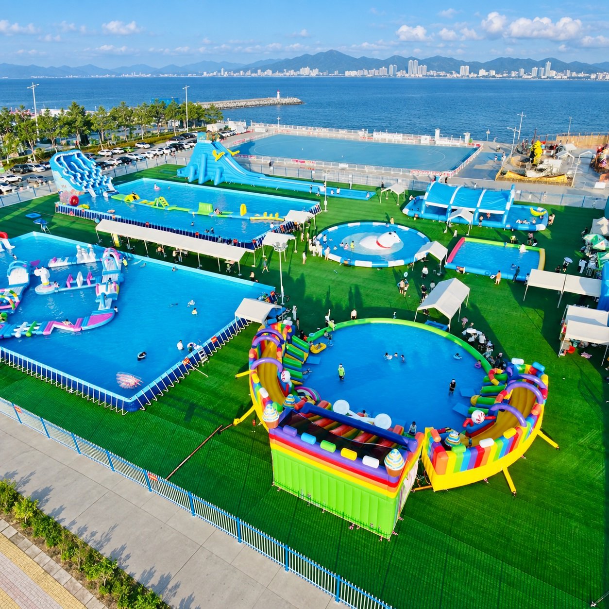 Aerial view of a waterfront inflatable water park with multiple pools