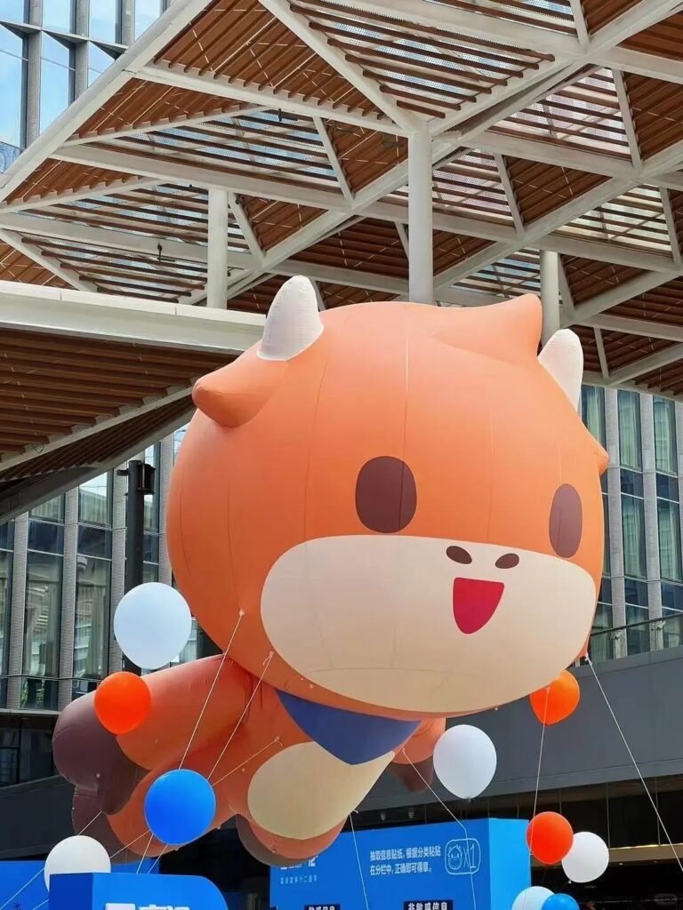 Orange inflatable cartoon animal with horns and a blue outfit