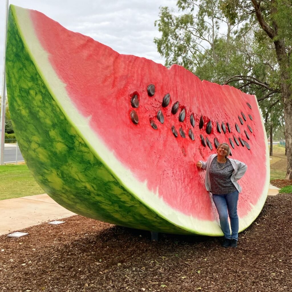 Giant inflatable watermelon slice with red flesh and black seeds