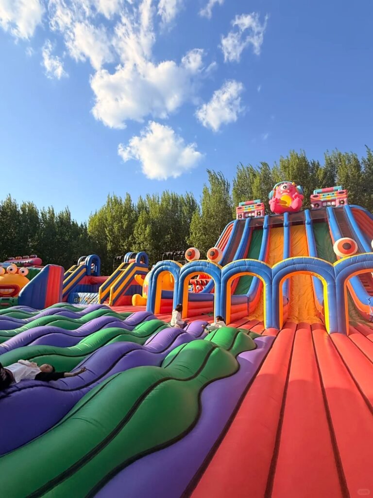 Large colorful inflatable slide complex with parallel lanes
