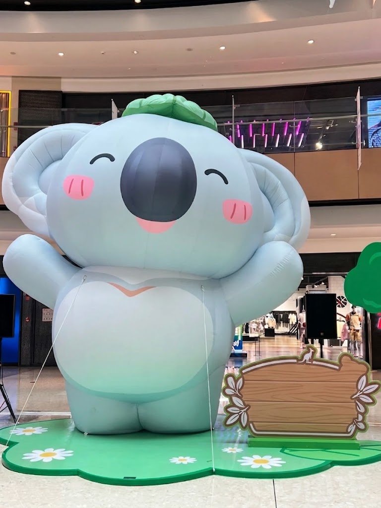 Pale blue inflatable koala character with rosy cheeks