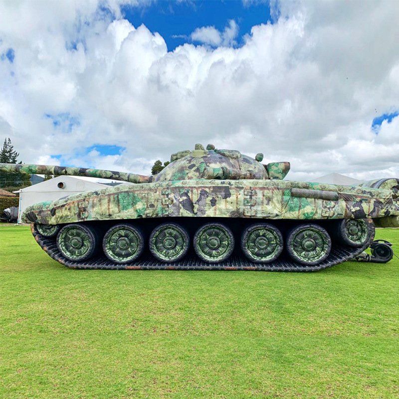 Side view of a camouflage inflatable tank model on grass