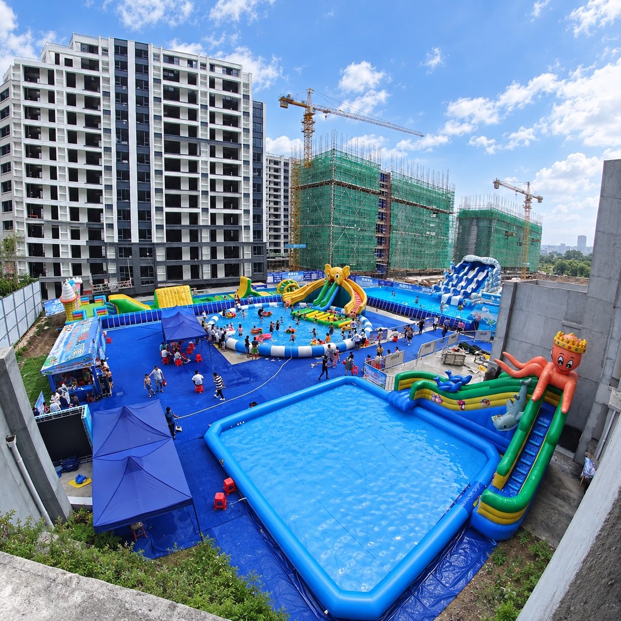 Aerial view of inflatable pools and water slides beside apartment buildings
