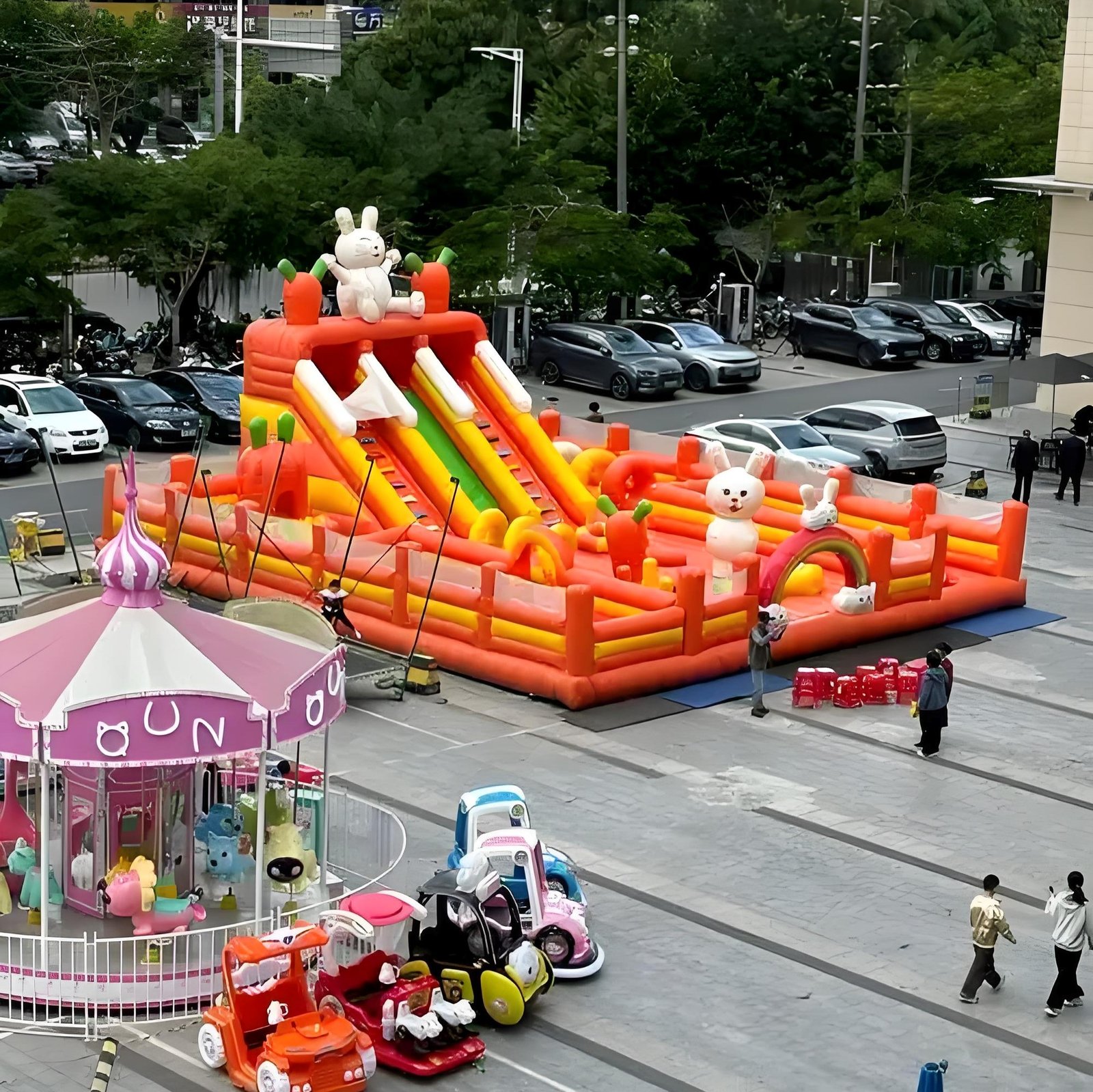 Orange inflatable playground with slides and rabbit decorations