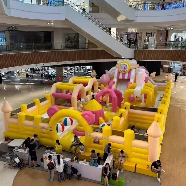 Pastel castle-themed inflatable playground in a shopping mall