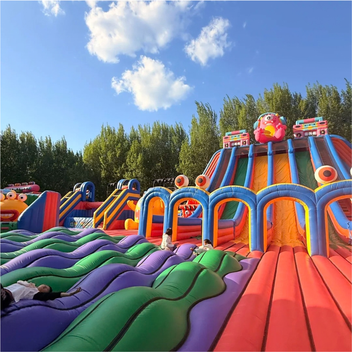 Large colorful inflatable slide complex with parallel lanes