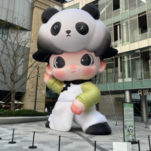 Giant inflatable character wearing a panda costume