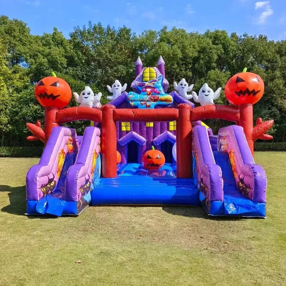 Halloween-themed inflatable bounce house with slides, ghosts, and pumpkins