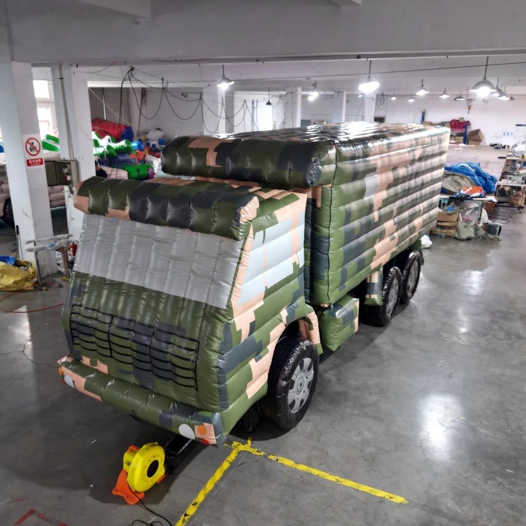 Camouflage inflatable military truck model in a workshop