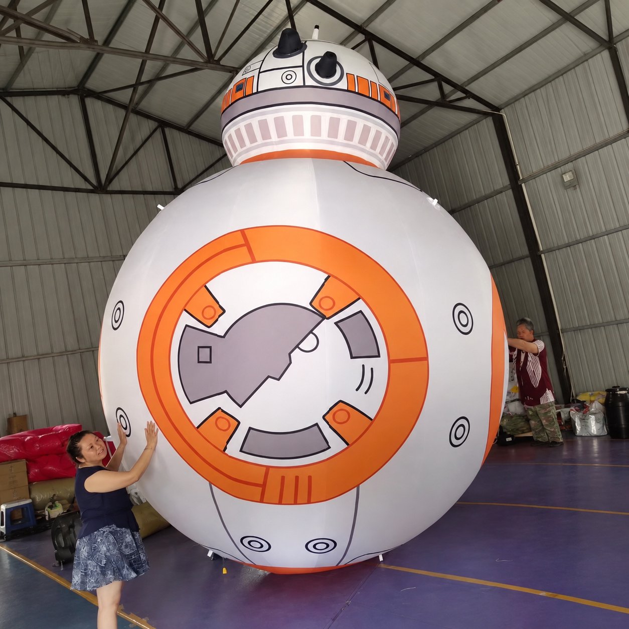 Round white and orange inflatable robot with a domed head