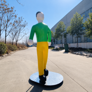 Inflatable human mannequin wearing a green shirt and yellow pants