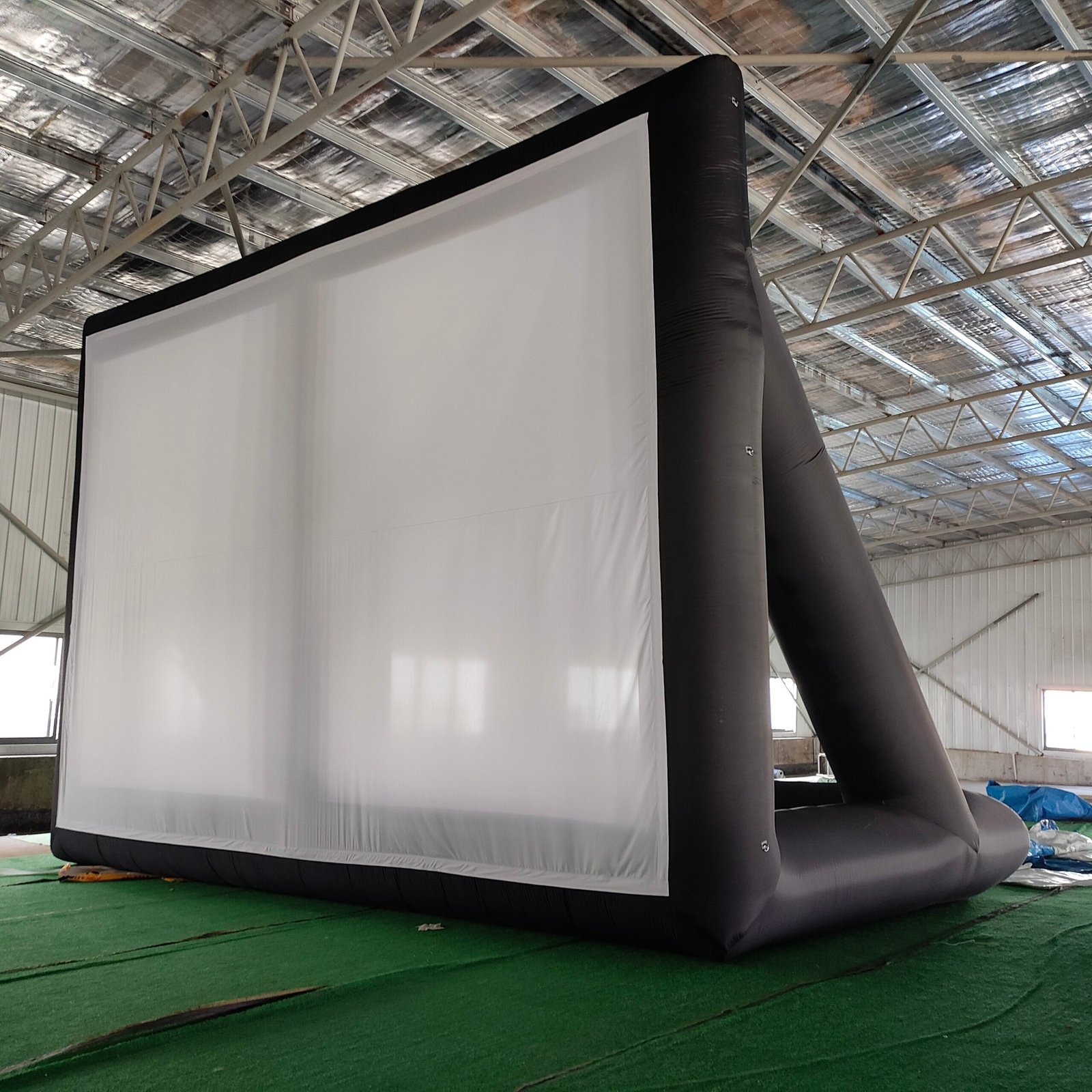 Black inflatable projection screen with triangular rear supports