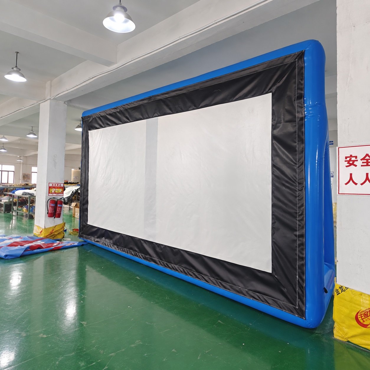Inflatable projection screen with a white surface and black and blue frame