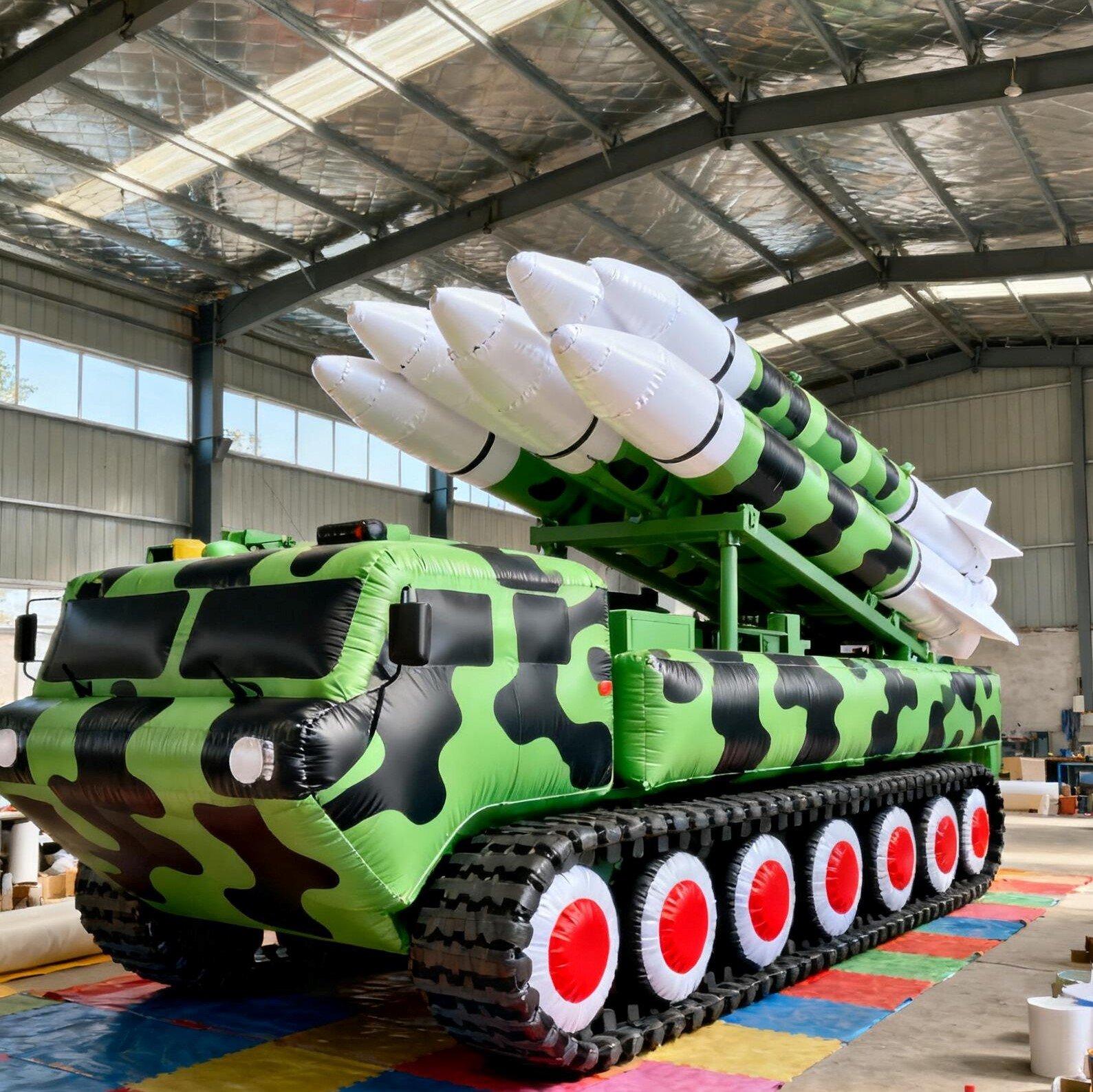 Green camouflage inflatable tracked vehicle model with white-tipped rockets