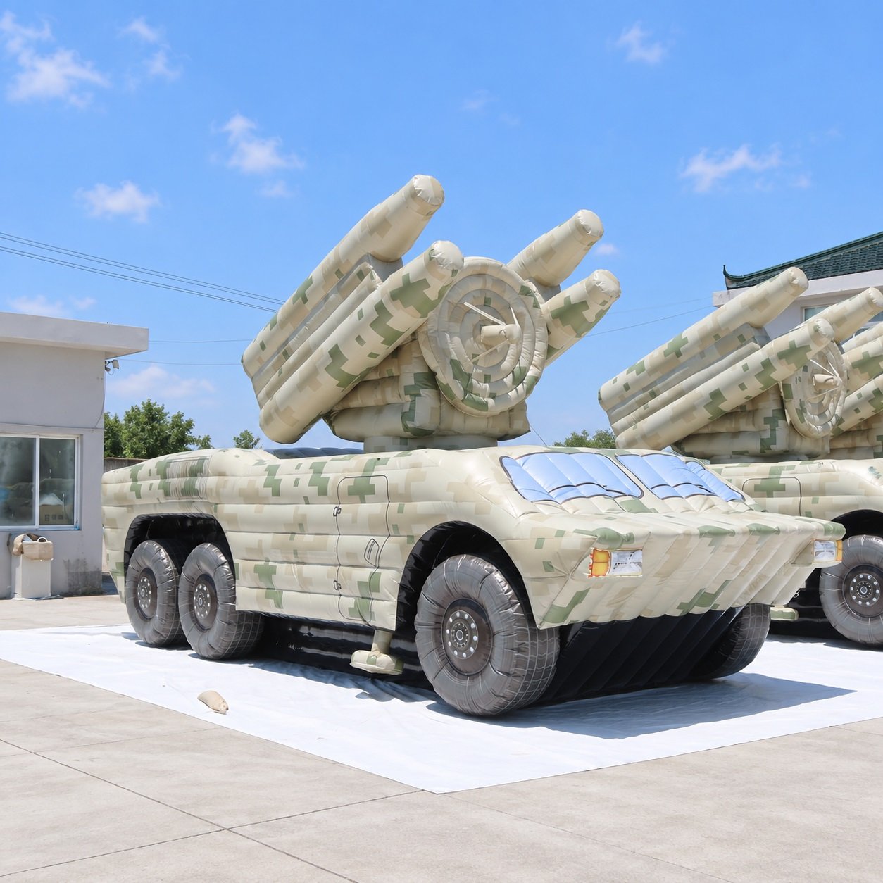Camouflage inflatable military vehicle model with raised launcher tubes