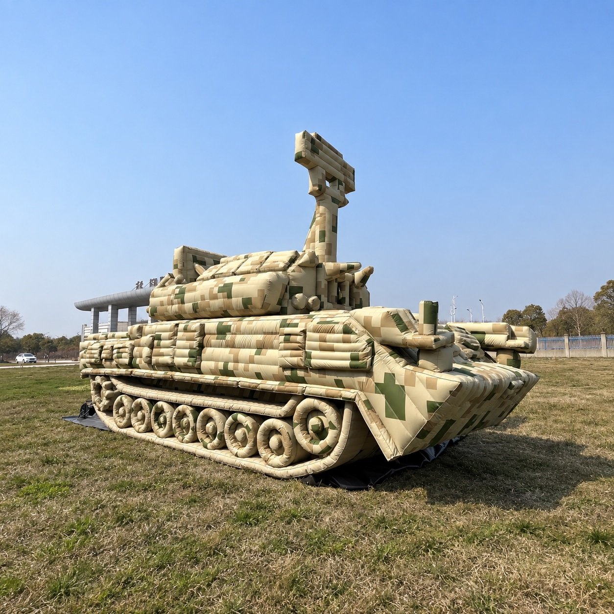 Camouflage inflatable tracked military vehicle model with a raised antenna