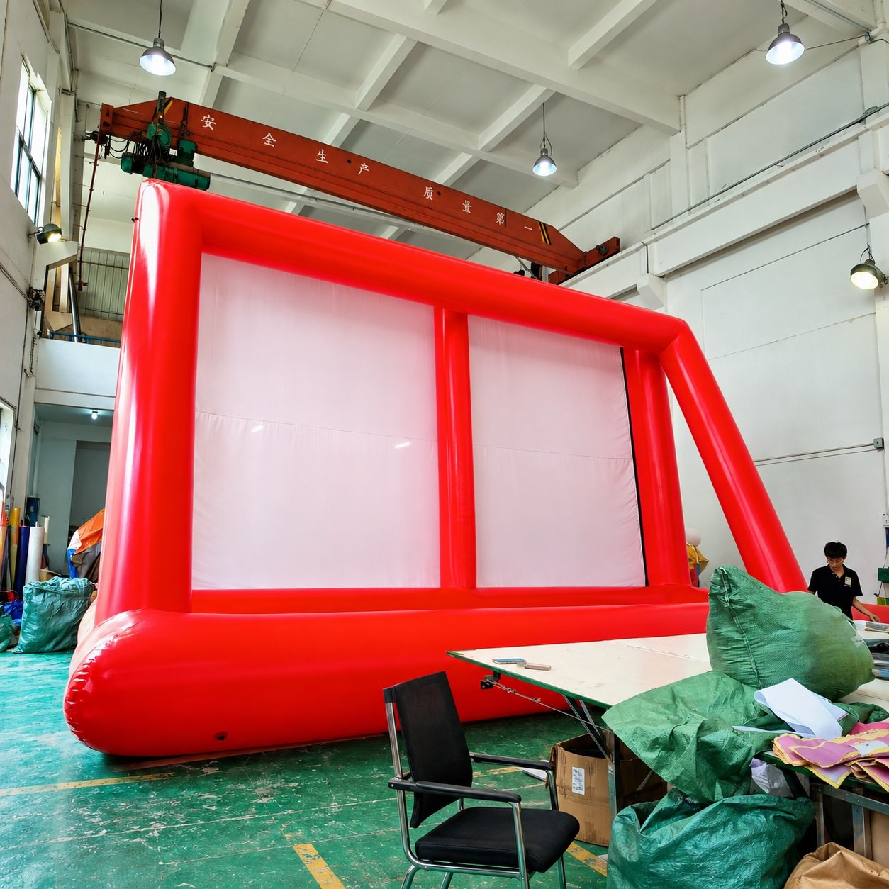 Red inflatable projection screen with a white surface inside a workshop