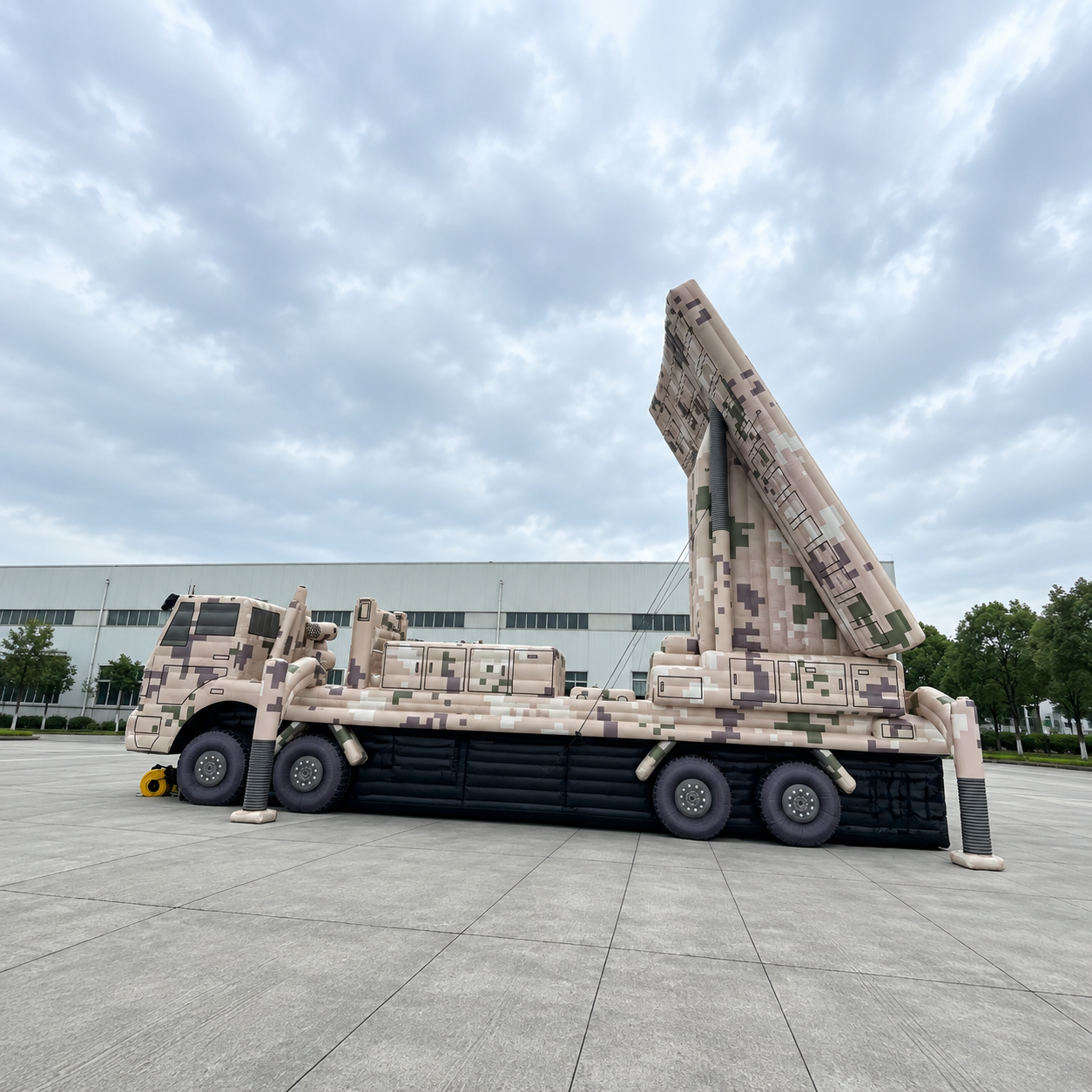 Camouflage inflatable military vehicle model with a raised launcher