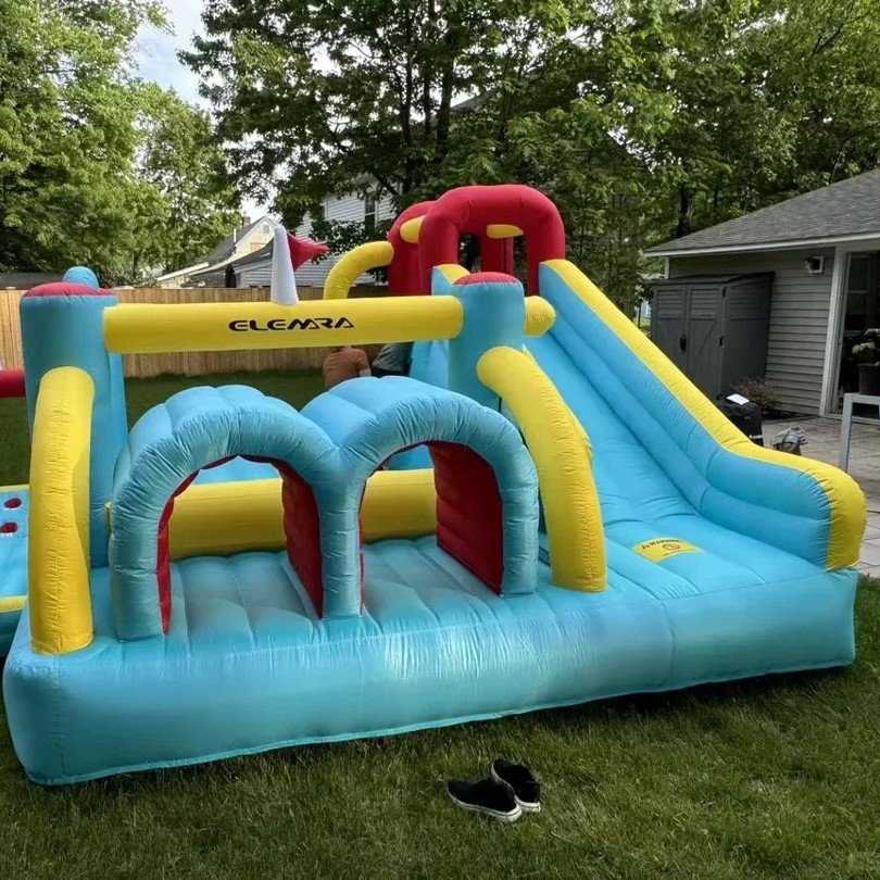 Blue and yellow inflatable bounce house with mesh walls and a slide